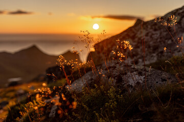 Felskante mit Sonnenuntergang im Hintergrund