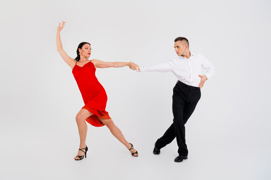 Full size photo of two young passionate dancing partners argentinian tango isolated on white color background