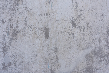 textured wall surface with a rough, uneven pattern. The wall appears to be made of concrete or plaster, with various shades of gray and white.