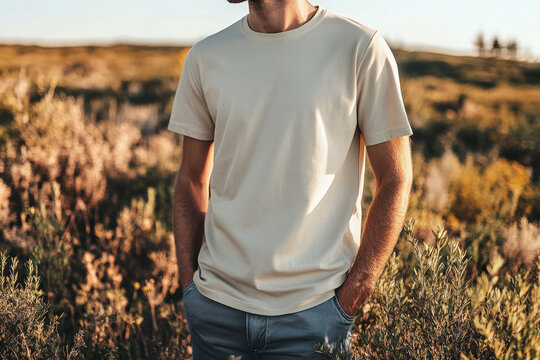 Close-up of a young man wearing a blank beige t-shirt with hands in pockets, perfect for showcasing your apparel design