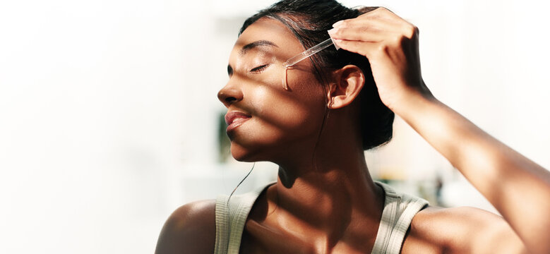 Home, woman and face with serum for skincare, wellness and moisture for self care by mockup space. Collagen, female person and cosmetics with dropper for beauty, oil treatment and vitamin c in house