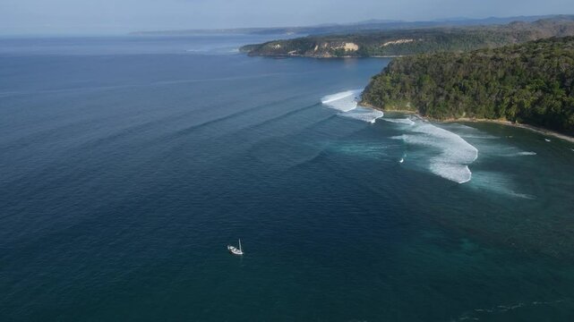 Aerial view of a small sailing boat moored off the coast of Sumba Island.Indonesia