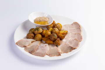 Ham and new potatoes in a plate.