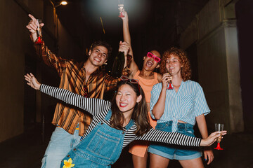 Friends going out in the evening and making party. Young people meeting outdoor in the weekend and celebrating together.