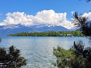 A lake in the Swiss Alps. The Blue Lake in Switzerland. Snow-capped mountains near the lake. Spring.