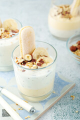 Milk mousse dessert with nuts in glasses	