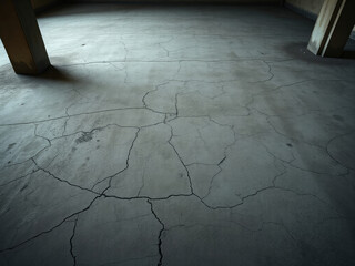 Pitted and cracked concrete floor in abandoned building, floor, worn, old, weathered