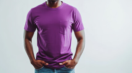 man wearing a vibrant purple t-shirt, standing casually with his hands in his pockets, smiling softly, against a crisp white background