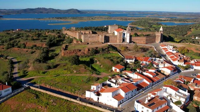 Mourao - scenic Portuguese medieval village in Alentejo,District of Evora. aerial high angle 4k hd video of fortified town with castle  and Alqueva lake