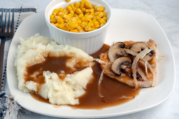onions and mushrooms on a boneless pork chops
