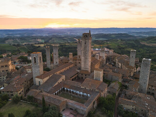 Obraz premium Aerial view of San Gimignano medieval town towers skyline and countryside landscape on sunrise. Tuscany, Italy.