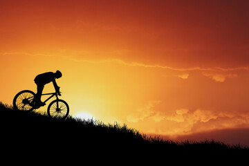 Sunset Mountain Biking Silhouette: A lone cyclist's silhouette is captured against a vibrant, fiery sunset, conveying a sense of adventure, freedom, and the pursuit of goals.