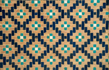 Closeup wall decorated with colored pattern of eastern, ceramic, porcelain mosaic in Uzbekistan, Asia