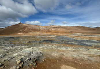 barren landscape of a geothermal area Hverir with colorful mineral soil