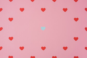 Red hearts pattern, paper cut romantic concept, top view. Beautiful blue and red hearts on pastel pink background with copy space. Valentines Day greeting card concept. Flat lay art. .