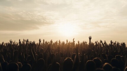 Obraz premium Silhouetted crowd at sunset with raised hands.