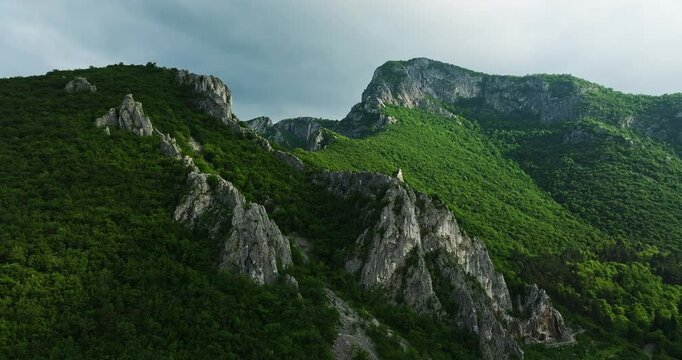 Vibrant Green Mountains Cliffs Runrays Bursting Through Clouds Aerial Fpv Fly Through