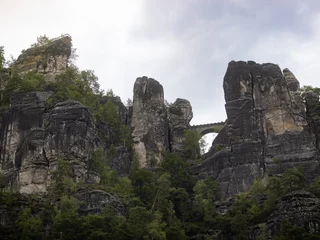 Bastei bridge seen from the Elbe river. Building in between the sandstones of the Saxon Switzerland. Tourist attraction in Saxony. Beautiful nature in Germany.