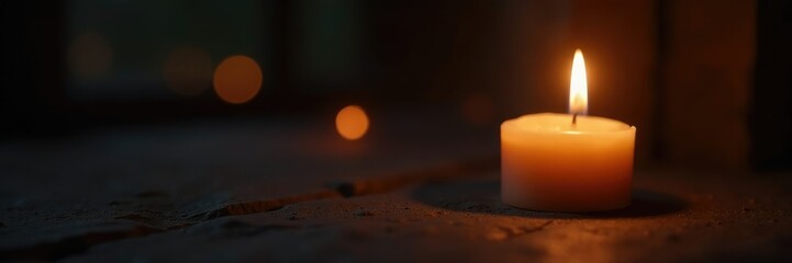 Flickering white candle in a small, dimly lit space with low light, candle flame, night, fire