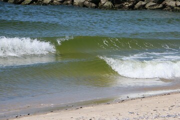 close-up of small waves breaking just before the beach