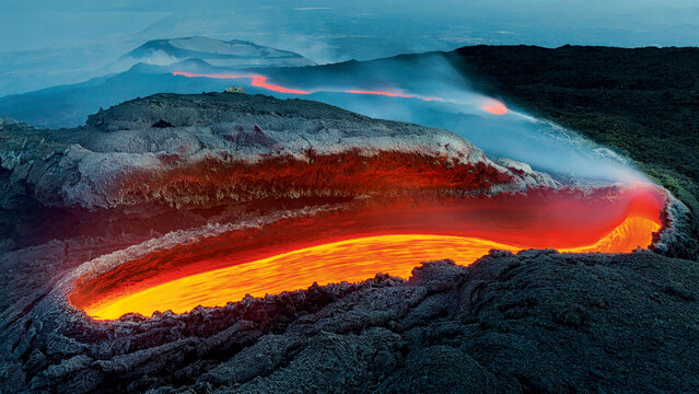 Etna&rsquo;s River of Fire. Lava flowed from a great opening on the side of the volcano as an incandescent red river. Winner of Wildlife Photographer of the Year, most important award for Nature photography