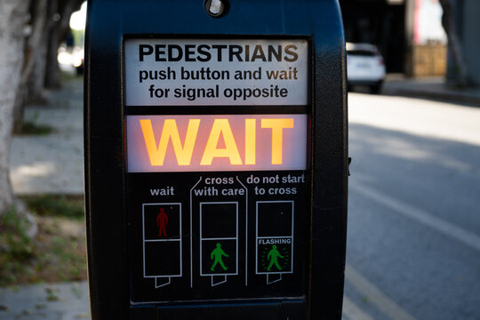 Electronic traffic light to cross a busy street in central Nicosia, Cyprus. Wait sign lights up, symbolizing modern traffic safety systems