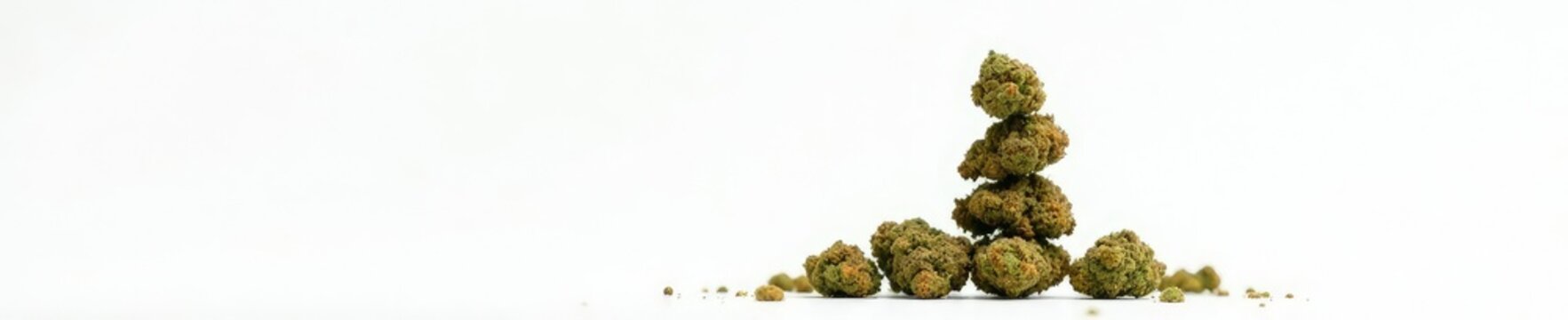Stack of cannabis nugs in a vertical column on white, cannabis, bud