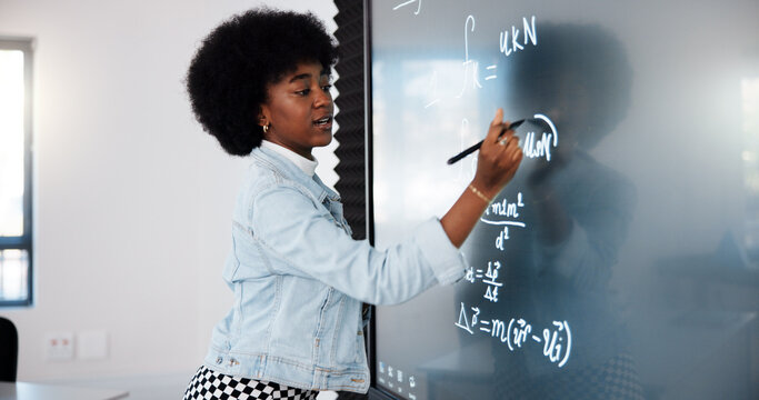 Education, black woman and student by board in classroom explaining science equation at college. Revision, lecture and female person with physics research for university exam, test or assignment.
