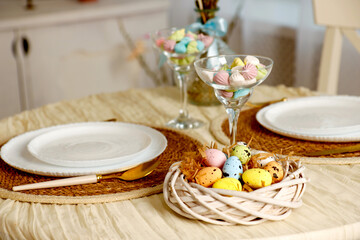 table set for two decorated with an Easter basket with painted eggs, Easter content