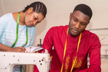 Tailor teaching a skill or discussing design ideas with an apprentice or colleague.
