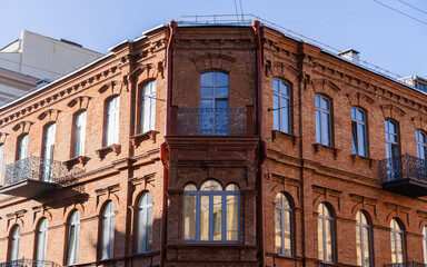 A corner, old building in Minsk. Sunlight falls on the building
