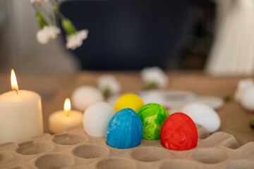 Decorating colorful Easter eggs with a palette and candles during spring festivities