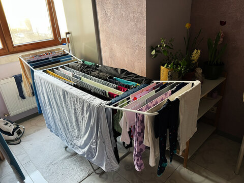 Interior space with clothes drying on racks and natural lighting
