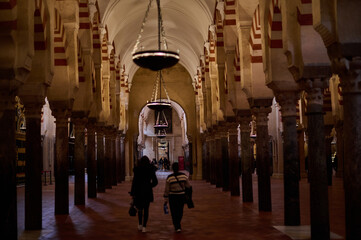 The interior of the Mosque-Cathedral of Córdoba, featuring its iconic columns and horseshoe arches, a masterpiece of Moorish and Spanish architecture in Andalusia, Spain