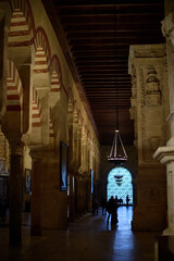 The interior of the Mosque-Cathedral of Córdoba, featuring its iconic columns and horseshoe arches, a masterpiece of Moorish and Spanish architecture in Andalusia, Spain
