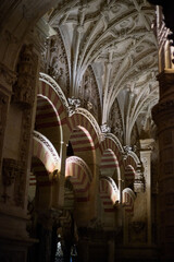 The interior of the Mosque-Cathedral of Córdoba, featuring its iconic columns and horseshoe arches, a masterpiece of Moorish and Spanish architecture in Andalusia, Spain