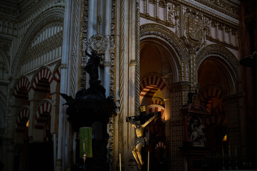 The interior of the Mosque-Cathedral of Córdoba, featuring its iconic columns and horseshoe arches, a masterpiece of Moorish and Spanish architecture in Andalusia, Spain