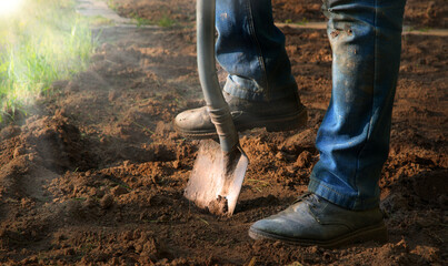 Man's feet with a shovel