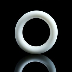 White ceramic circular ring on black reflective surface display