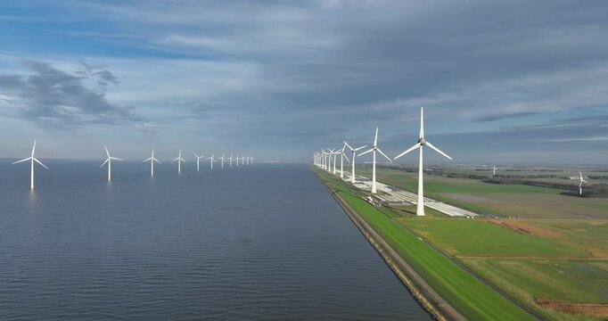 Onshore and offshore wind farm, modern windmills wind turbines, intended to generate wind energy. Placement in the sea, high-voltage installation