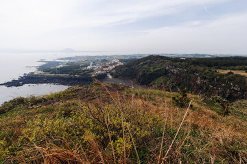 Obraz premium Udo Island, Jeju Island province, South Korea, Jeju-do, panoramic aerial view of coastline sea landscape in a sunny day, U-do Island, Soseom cow island, Jeju-si