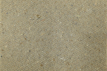 Macro of recycled cardboard with rough fibers and imperfections. Earthy tones, great for eco-friendly designs.