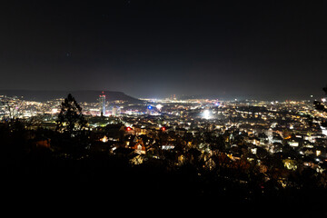 Naklejka premium View of Jena in Thuringia from the Landgrafen viewpoint in the early hours of New Year's Eve 2025