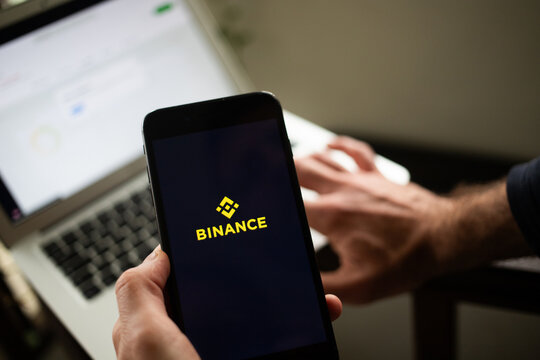 person opening binance crypto exchange app on a phone