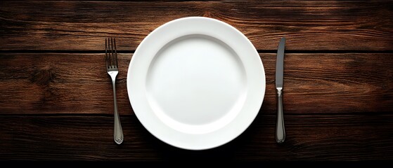 Empty White Plate with Fork and Knife on Rustic Wooden Table