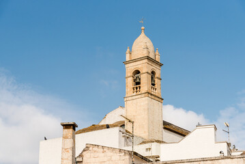 Obraz premium The bell tower of the Santa Lucia Church in the ancient village of Alberobello, Puglia, Italy