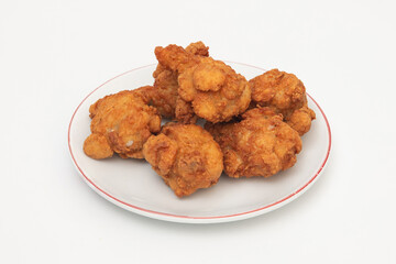 Generated imageFried chicken wings on a plate on a white background, close-up
