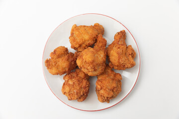 Generated imageFried chicken wings on a plate on a white background, close-up