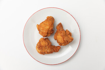 Generated imageFried chicken wings on a plate on a white background, close-up