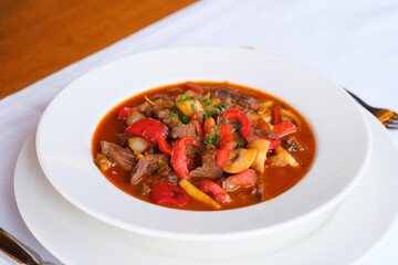 Hearty beef stew with red peppers and mushrooms